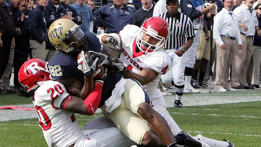 October 23, 2010; Pittsburgh,PA, USA; Pittsburgh Panthers receiver Jon Baldwin (82) catches a pass between Rutgers Scarlet Knights defenders Khaseem Green (20) and David Rowe (4) during the third quarter at Heinz Field. Pittsburgh won 41-21. Mandatory Credit: Charles LeClaire-USPRESSWIRE