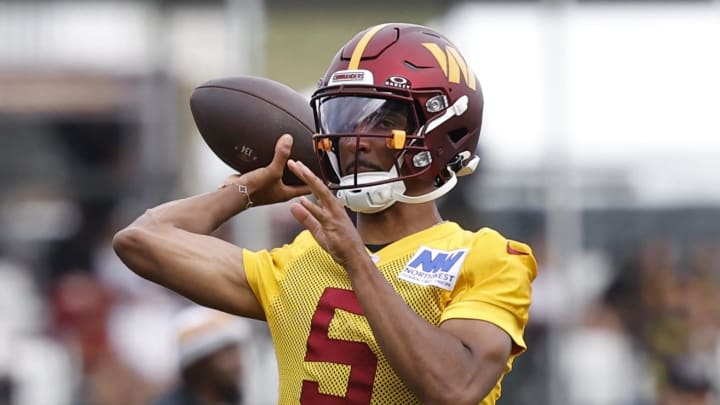 Jul 26, 2024; Ashburn, VA, USA; Washington Commanders quarterback Jayden Daniels (5) passes the ball on day three of training camp at Commanders Park. Mandatory Credit: Geoff Burke-USA TODAY Sports