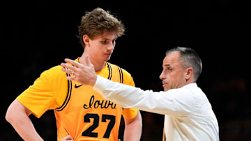 Iowa head coach Ben McCollum with center Trevin Jirak (27) 