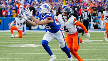 Buffalo Bills tight end Dalton Kincaid (86) puts his hands up and catches successfully the pass while Denver Broncos safety P.J. Locke (6) keeps pace with him during the second half of the Buffalo Bills wild card game against the Denver Broncos at Highmark Stadium in Orchard Park on Jan. 12, 2025.