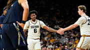 Iowa’s Tavion Banks (6) high-fives Iowa center Trevin Jirak (27)