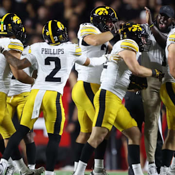 Iowa Hawkeyes defense celebrates an interception