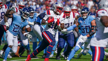 The Tennessee Titans defense scrambles for a stop against the New England Patriots