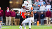 Nov 22, 2025; Blacksburg, Virginia, USA; Virginia Tech Hokies quarterback Kyron Drones (1) sacked by Miami Hurricanes Chase Smith (41) during the second quarter at Lane Stadium. 