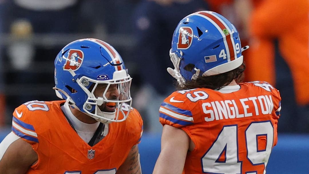 Jan 4, 2026; Denver, Colorado, USA; Denver Broncos linebacker Justin Strnad (40) celebrates with linebacker Alex Singleton (49) after a sack during the second half against the Los Angeles Chargers at Empower Field at Mile High. Mandatory Credit: Isaiah J. Downing-Imagn Images