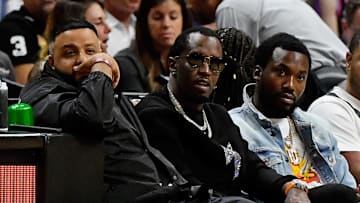 Jan 2, 2020; Miami, Florida, USA; Recording artists DJ Khaled (R) sits with Sean  Diddy  Combs (C) and Meek Mill (L) during the first half between the Miami Heat and the Toronto Raptors at American Airlines Arena. Mandatory Credit: Jasen Vinlove-Imagn Images