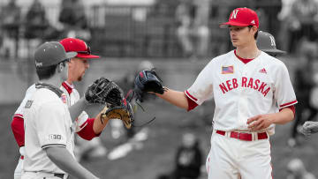 Spencer Schwellenbach (left) and Cade Povich (right) meet with teammates during a mound visit against Maryland in the 2021 season.