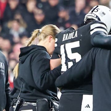 Nebraska quarterback Dylan Raiola is helped off the field after suffering an injury against USC.