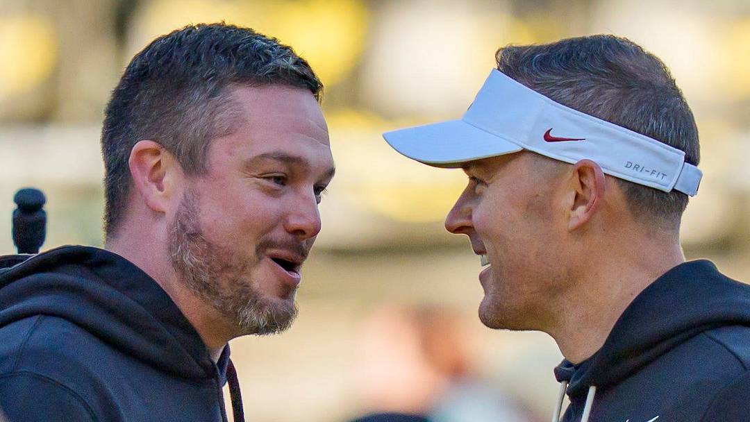Oregon head coach Dan Lanning, left, and USC head coach Lincoln Riley shake hands before the game as the Oregon Ducks host the USC Trojans on Nov. 22, 2025, at Autzen Stadium in Eugene, Oregon.