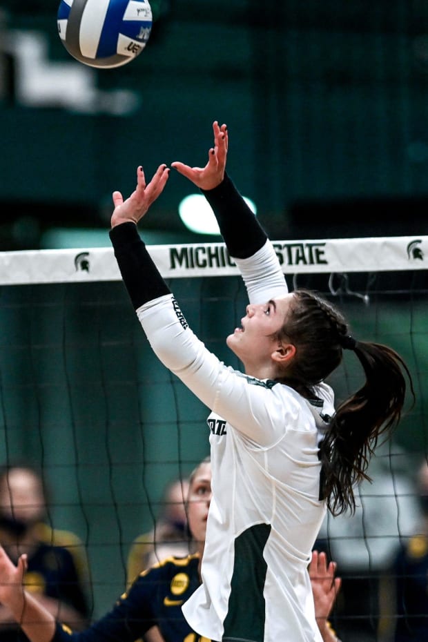 Michigan State's Celia Cullen sets the ball to a teammate during the first set against Michigan on Wednesday, Feb. 17, 2021.