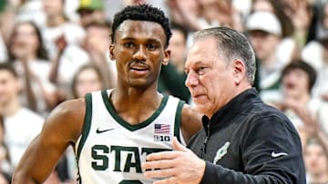 Michigan State's Tyson Walker, left, talks with head coach Tom Izzo during the first half in the