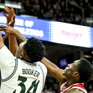 Michigan State's Xavier Booker, left, dunks and is fouled by Ohio State's Scotty Middleton during the second half on Sunday, Feb. 25, 2024, at the Breslin Center in East Lansing.