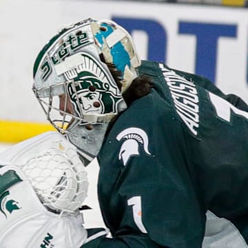 Michigan State goaltender Trey Augustine makes a save against Michigan right wing Gavin Brindley during the third period at Yost Ice Arena in Ann Arbor on Friday, Feb. 9, 2024.