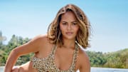 Chrissy Teigen was photographed by Yu Tsai in Los Angeles. Swimsuit by Natalia Fedner.  Earrings by Jacquie Aiche. Wrist Chain by Jacquie Aiche
