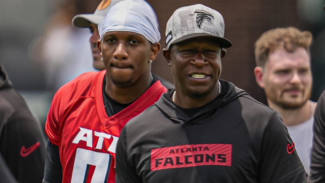 Atlanta Falcons quarterback Michael Penix Jr. (9) and head coach Raheem Morris on the field during Minicamp at Children's Healthcare of Atlanta Training Ground.