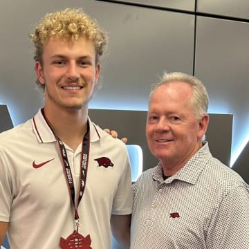 Arkansas Razorbacks quarterback commit Grayson Wilson with Razorbacks offensive coordinator Bobby Petrino during the 2024 Hog Wild Hangout.