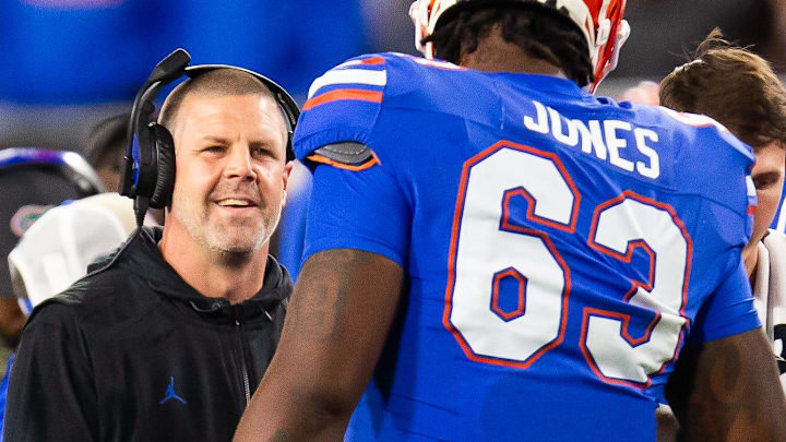Florida Gators head coach Billy Napier jokes around with Florida Gators offensive lineman Caden Jones (63) during the second half at Raymond James Stadium in Tampa, FL on Friday, December 20, 2024 in the 2024 Union Home Mortgage Gasparilla Bowl. The Gators defeated Tulane 33-8. [Doug Engle/Gainesville Sun]