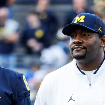 Michigan safeties coach Ron Bellamy watches warmups next to wide receiver Ronnie Bell before the Rutgers game at Michigan Stadium in Ann Arbor on Saturday, Sept. 25, 2021.