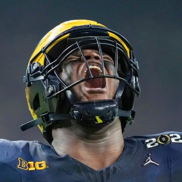 Michigan defensive lineman Kenneth Grant (78) celebrates a sack on Washington quarterback Michael Penix Jr. (9) in the second quarter during the College Football Playoff national championship game against Washington at NRG Stadium in Houston, Texas on Monday, January 8, 2024.