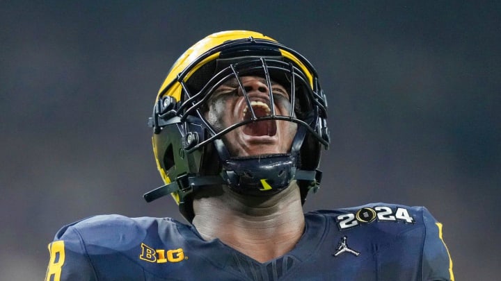 Michigan defensive lineman Kenneth Grant (78) celebrates a sack on Washington quarterback Michael Penix Jr. (9) in the second quarter during the College Football Playoff national championship game against Washington at NRG Stadium in Houston, Texas on Monday, January 8, 2024.