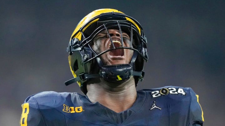 Michigan defensive lineman Kenneth Grant (78) celebrates a sack on Washington quarterback Michael Penix Jr. (9) in the second quarter during the College Football Playoff national championship game against Washington at NRG Stadium in Houston, Texas on Monday, January 8, 2024.