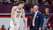 Neoklis Avdalas and Mike Young talk during a dead ball in the season opener vs Charleston Southern. Credit - Virginia Tech Athletics