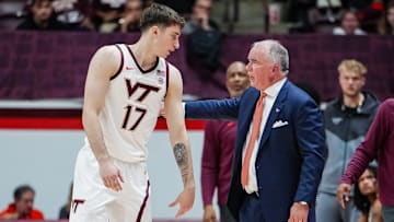 Neoklis Avdalas and Mike Young talk during a dead ball in the season opener vs Charleston Southern. Credit - Virginia Tech Athletics