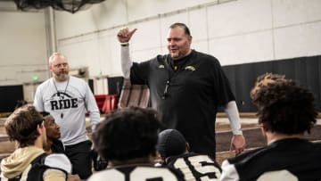 Western Michigan defensive coordination/defensive line coach Lou Esposito speaks with defensemen on
