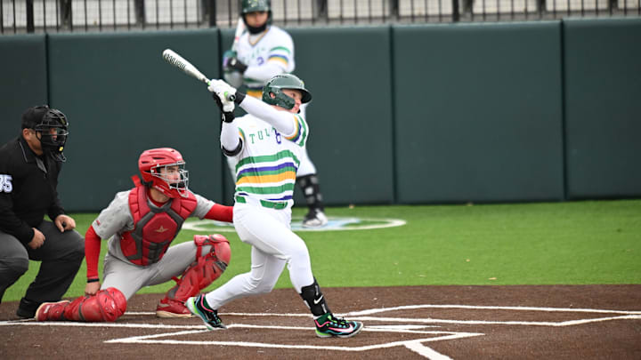 Tulane second baseman swings at the plate. Tulane second baseman swings at the plate.