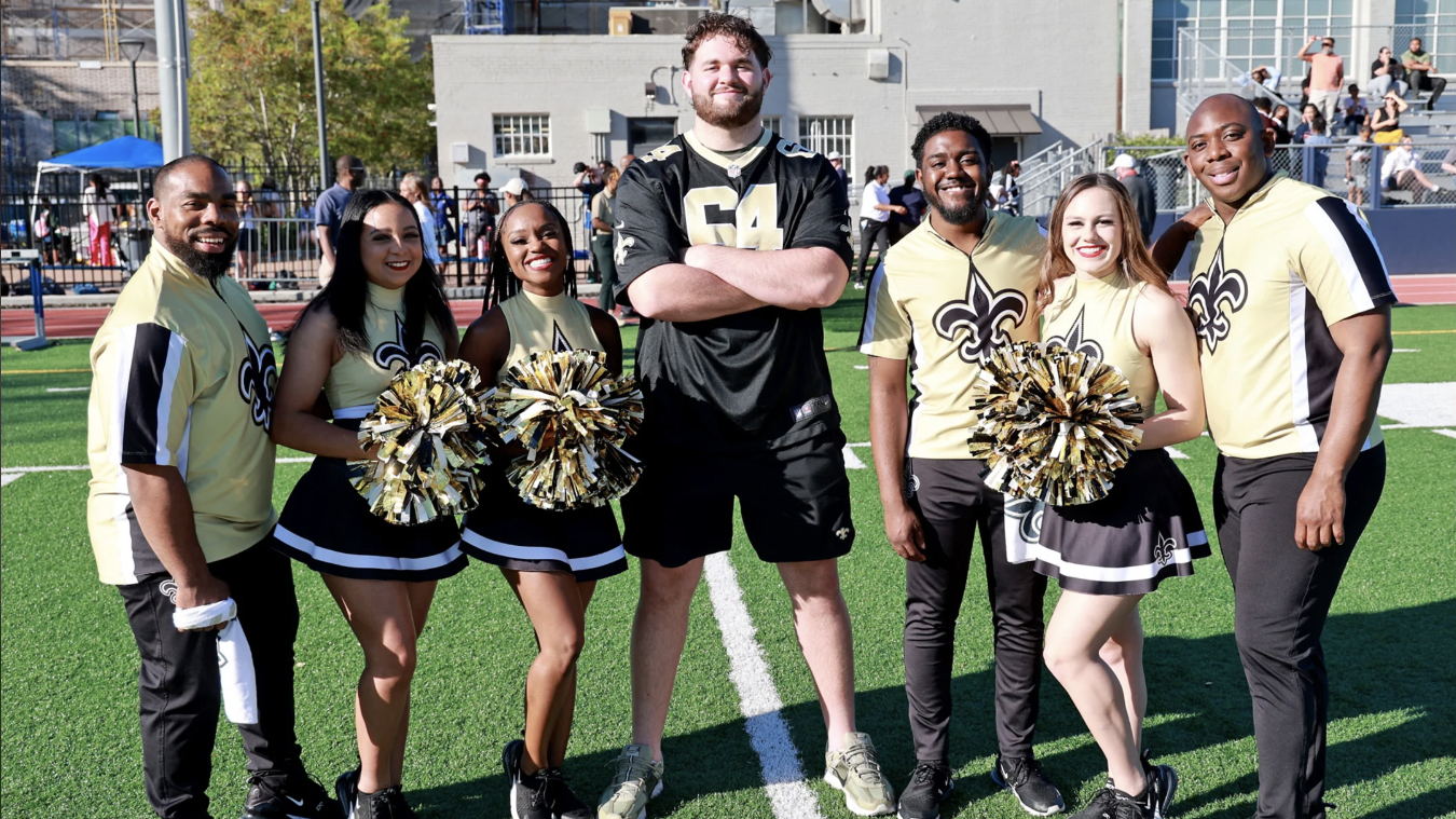 New Orleans Saints OL Nick Saldiveri and members of the Saints Cheer Krewe were on hand for the opening action.