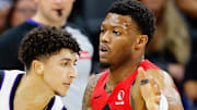 Sacramento Kings guard Nique Clifford controls the ball against Toronto Raptors guard Alijah Martin.