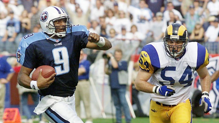 Tennessee Titans quarterback Steve McNair (9), making his first start after recovering from injury, scampers into the end zone for a touchdown as St. Louis Rams defender Todd Collins (54) arrives too late. The Titans upset the undefeated Rams 24-21 at Adelphia Coliseum on Oct. 21, 1999.