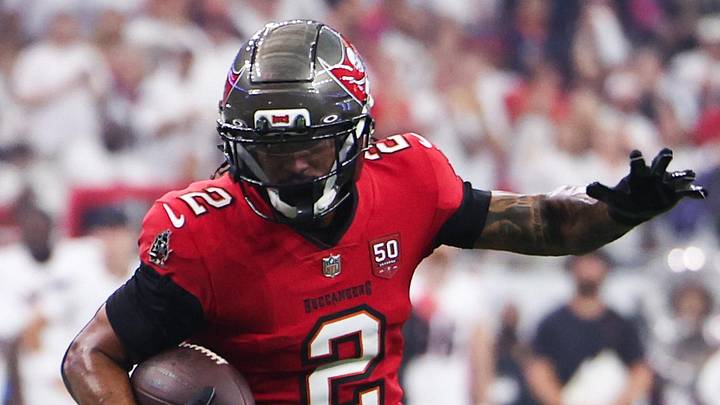 Tampa Bay Buccaneers wide receiver Emeka Egbuka runs for a touchdown as Houston Texans cornerback Kamari Lassiter.