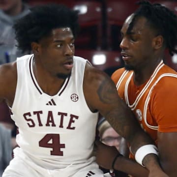 Mississippi State Bulldogs forward Cameron Matthews (4) dribbles as Texas Longhorns forward Arthur Kaluma (6) defends during the first half at FedExForum.