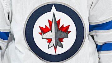 A Winnipeg Jets logo on a white jersey.