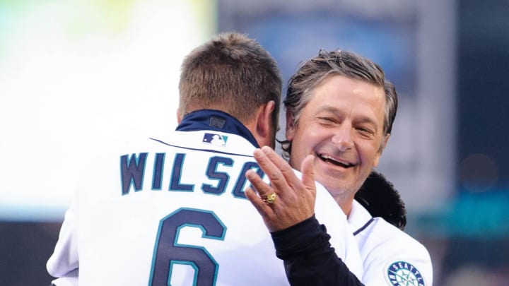 Former Seattle Mariners pitcher Jaime Moyer hugs former Seattle Mariners catcher Dan Wilson prior to the game between the Seattle Mariners and the Houston Astros at Safeco Field in 2013.