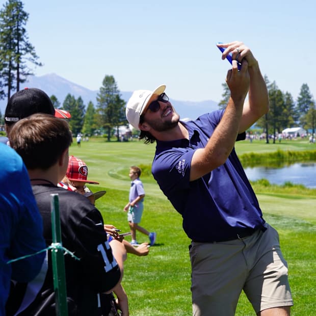 Josh Allen takes a selfie with a fan during an ACC practice round