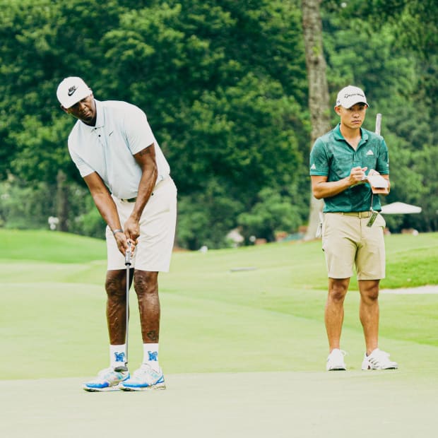 Penny Hardaway hits a putt while Collin Morikawa looks on