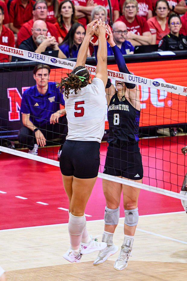 Rebekah Allick (5) fights for possession of the ball with Washington's Alexis Haury (8). 