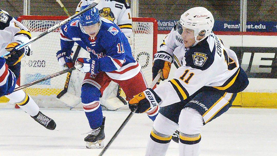 Erie Otters forward Dylan Edwards, right, competes against the Kitchener Rangers in the first period of the Otters home opener at Erie Insurance Arena in Erie on Sept. 20, 2025.