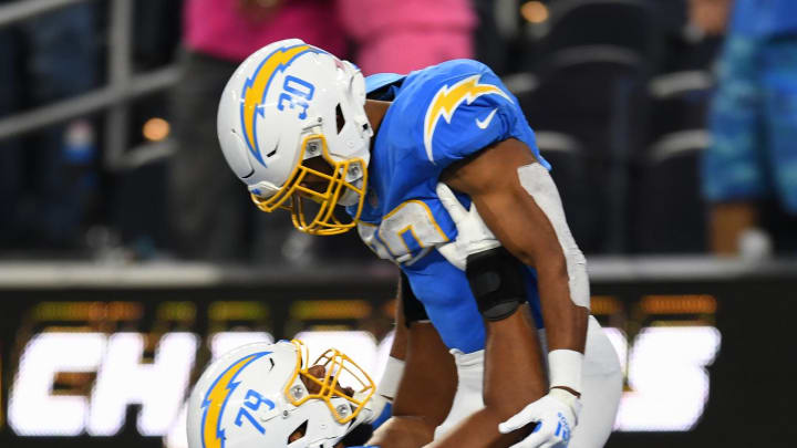 Oct 29, 2023; Inglewood, California, USA; Los Angeles Chargers offensive tackle Trey Pipkins III (79) celebrates with running back Austin Ekeler (30) after scoring a touchdown against the Chicago Bears during first quarter at SoFi Stadium. Mandatory Credit: Jonathan Hui-USA TODAY Sports