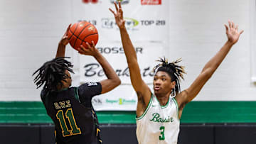 Bossier forward Kerel Woods (3) defending a 3-point shot by Calvary guard Tyrone Jamison (11) at the Bossier Basketball Invitational on Saturday, January 6, 2024, in Bossier City, La.