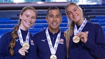 Nebraska volleyball players Bergen Reilly (left) and Andi Jackson (right) and assistant coach Jaylen Reyes (center) pose with their gold medals after winning the NORCECA U21 Continental Championship in Toronto.