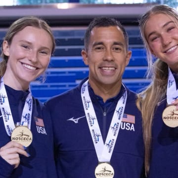 Nebraska volleyball players Bergen Reilly (left) and Andi Jackson (right) and assistant coach Jaylen Reyes (center) pose with their gold medals after winning the NORCECA U21 Continental Championship in Toronto.