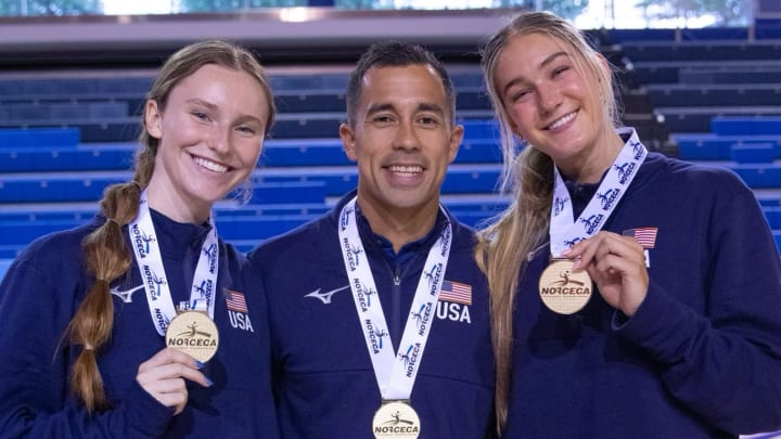 Nebraska volleyball players Bergen Reilly (left) and Andi Jackson (right) and assistant coach Jaylen Reyes (center) pose with their gold medals after winning the NORCECA U21 Continental Championship in Toronto.