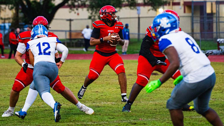 Monarch quarterback Florentino Lopez looks for a receiver during a recent game. Last week, the senior completed 20 of 25 passes for a whopping 434 yards and five touchdowns and rushed three times for 24 yards to lead the Knights past Fort Lauderdale High, 54-0. Monarch quarterback Florentino Lopez looks for a receiver during a recent game. Last week, the senior completed 20 of 25 passes for a whopping 434 yards and five touchdowns and rushed three times for 24 yards to lead the Knights past Fort Lauderdale High, 54-0.