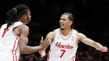 Houston's Milos Uzan (7) receives congratulations from teammate Joseph Tugler after Uzan's game-winning basket to beat Purdue on March 28, 2025.