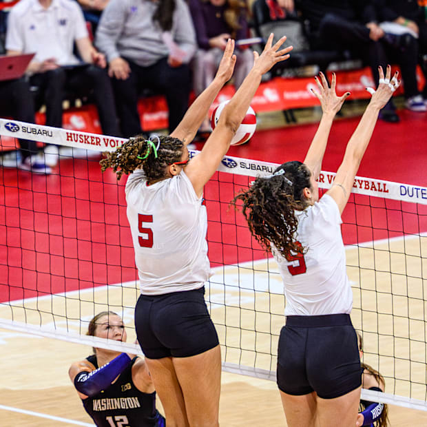 Rebekah Allick (5) gets a block on a Washington kill. 
