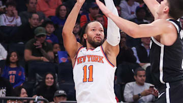Nov 9, 2025; New York, New York, USA;  New York Knicks guard Jalen Brunson (11) takes a three point shot past Brooklyn Nets guard Egor Demin (8) in the first quarter at Madison Square Garden. Mandatory Credit: Wendell Cruz-Imagn Images