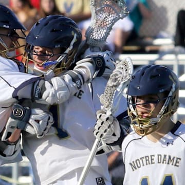 The Elmira Notre Dame boys lacrosse team celebrates a goal. The teams' coach, Geoff Crossley, was named a USA Coach of the Year.